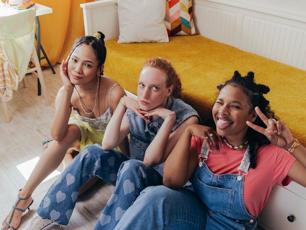 Diverse group of people smiling in a bright, airy room.